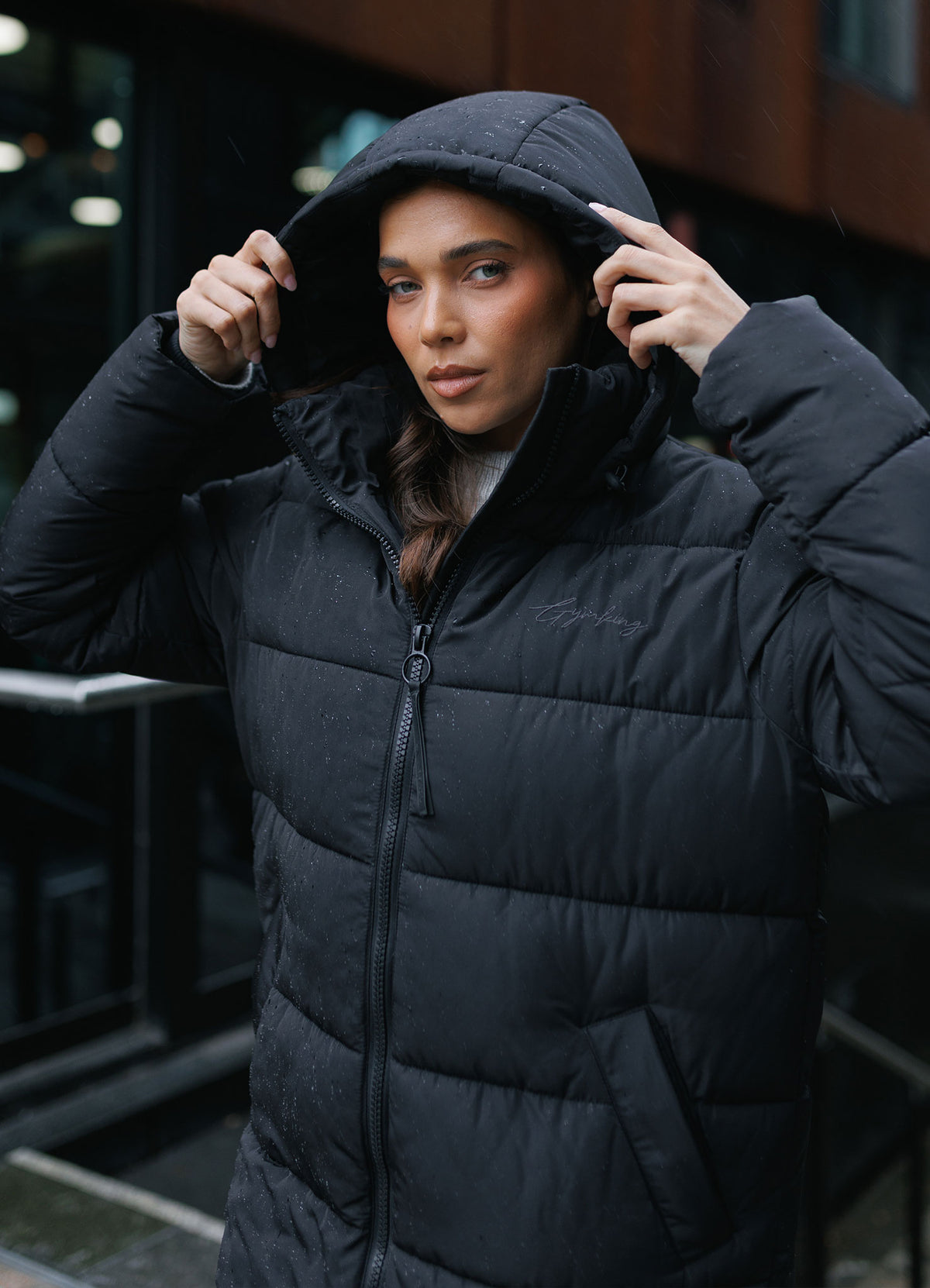 Gym King Longline Puffer Black women’s lightweight quilted jacket with full zip and side pockets